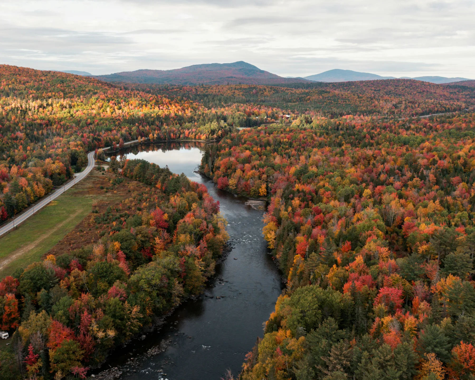 A river winding through Green Mountain foliage in fall