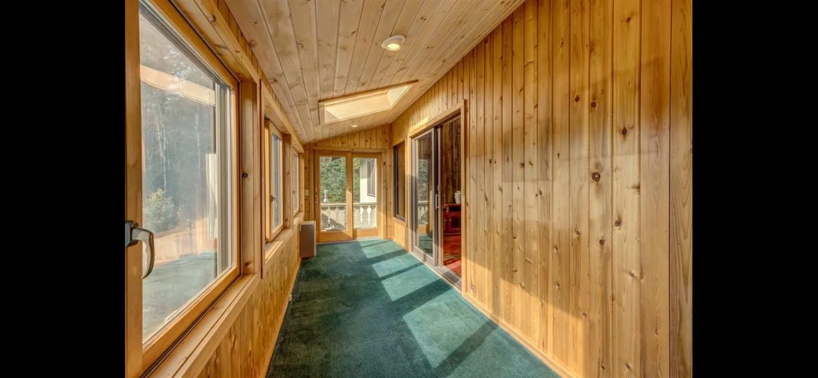 The pine-panelled sun-room passage