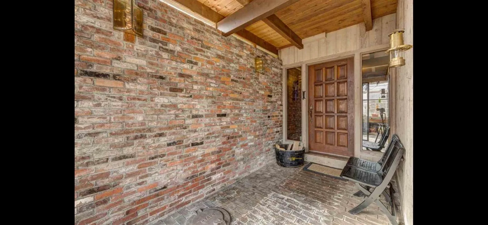 The brick entry porch and front door